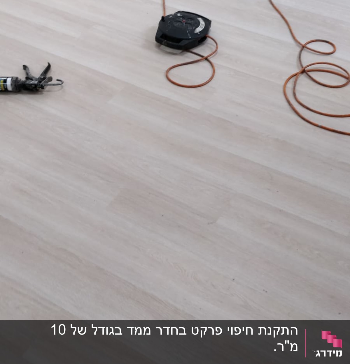 רצפת פרקט עם כבל חשמלי וכלי עבודה
